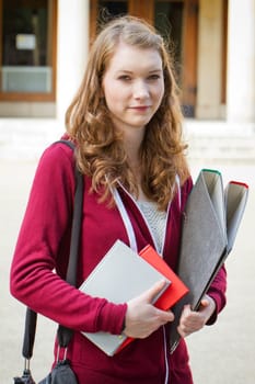 Student with folders and books in her hands