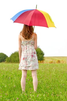 Young woman in summer with colorful umbrella