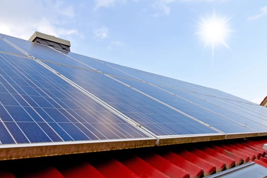 roof with solar panels and sun