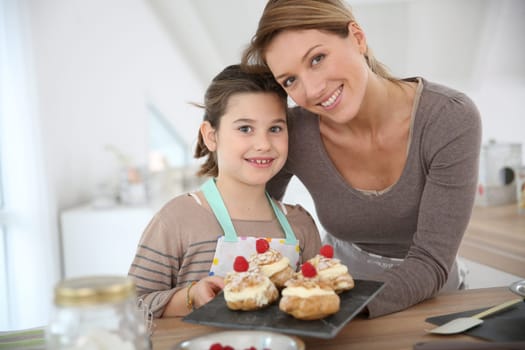 Mother and daughter preparing cream puffs