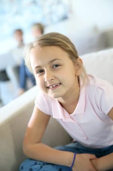 Portrait of 8-year-old girl sitting in sofa