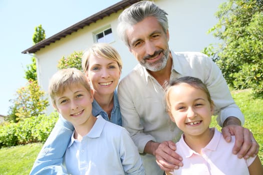 Happy family standing in home private garden