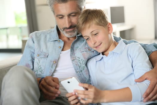Daddy with son playing with smartphone