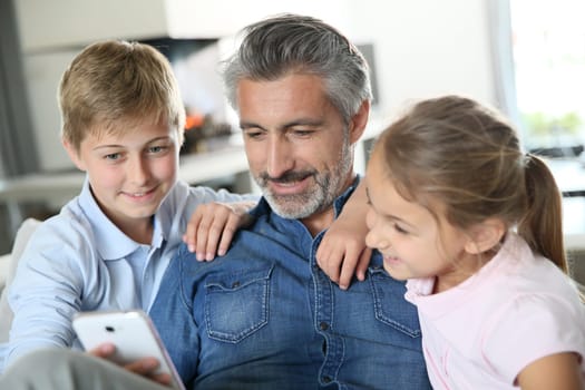 Man with kids playing with smartphone