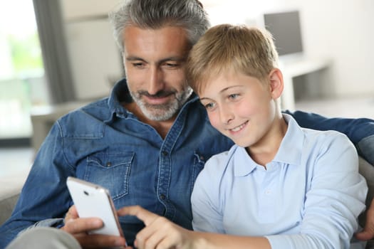 Daddy with son playing with smartphone