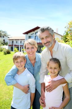 Happy family standing in home private garden