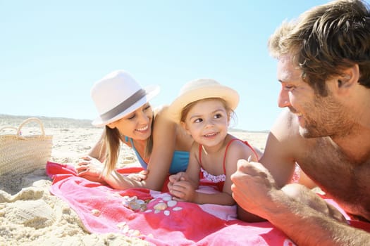 Family playing with seashells on the beach
