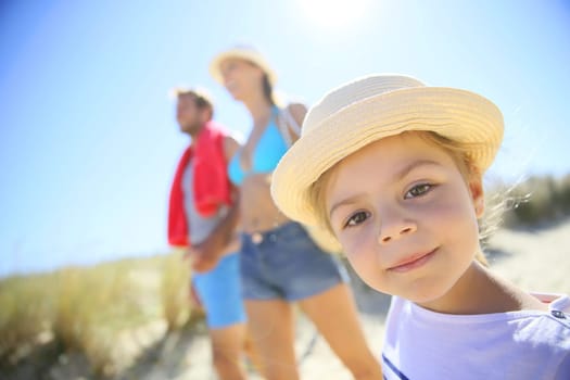 Family walking to the beach on a sunny day