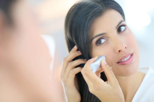 Portrait of beautiful woman using cosmetics
