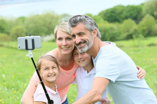 Family in vacation taking selfie picture with smartphone