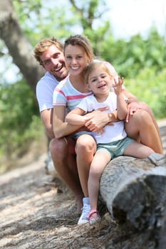 portrait of happy family sitting on a trunk