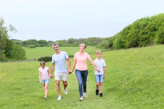 Family walking on country trail during vacation time