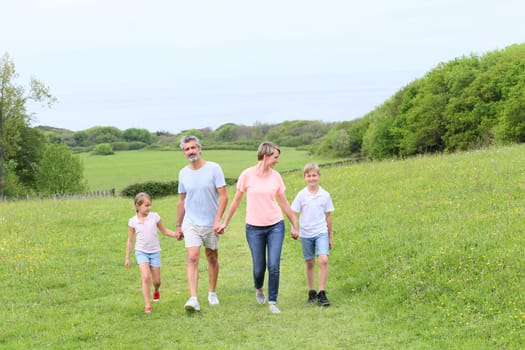Family walking on country trail during vacation time