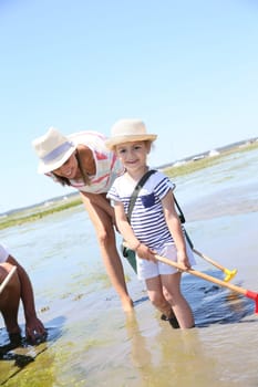 Family practicing recreational beach fisheries