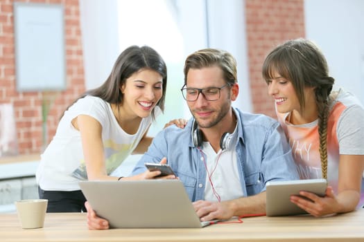 Group of friends connected together on laptop and tablet