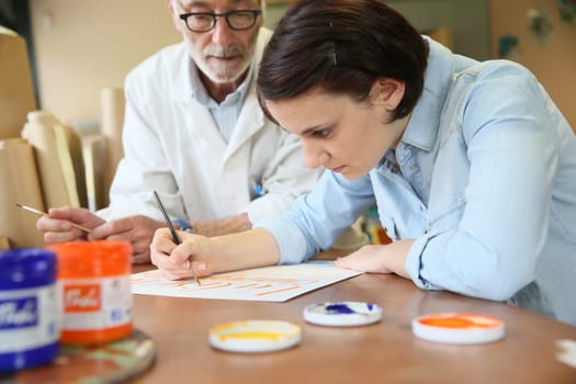 Young woman at school studying decorative painting