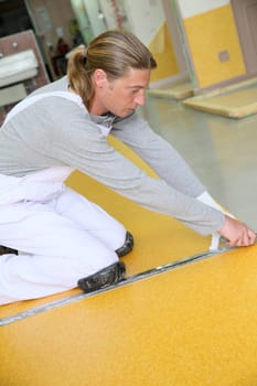 Craftsman installing plastic flooring