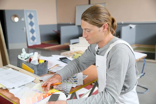 House painter preparing colour sample for house painting