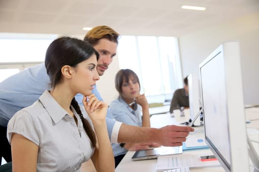 Business people working in office on desktop computer