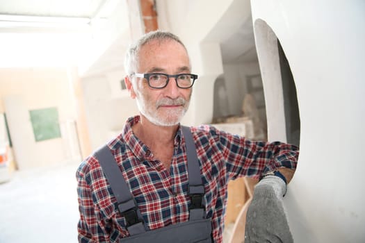 Portrait of senior craftsman in construction looking at camera