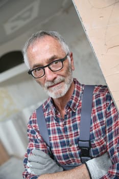 Portrait of senior craftsman in construction looking at camera