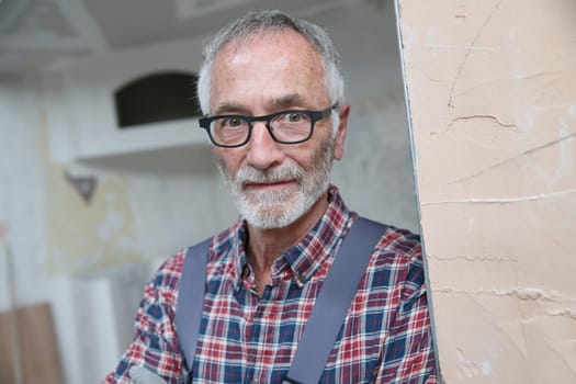 Portrait of senior craftsman in construction looking at camera