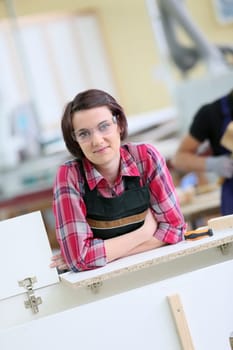 Portrait of young woman in carpentry school
