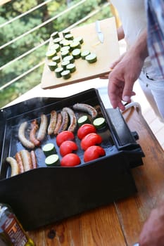 Closeup of man cooking grilled meat on barbecue