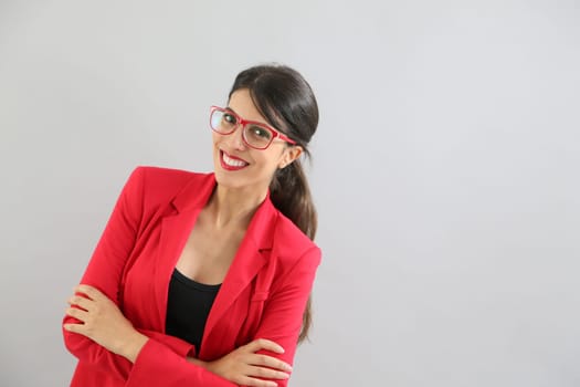 Beautiful brunette girl with red jacket and eyeglasses, isolated