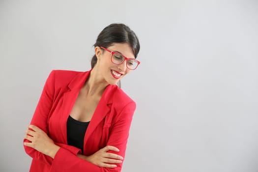 Beautiful brunette girl with red jacket and eyeglasses, isolated