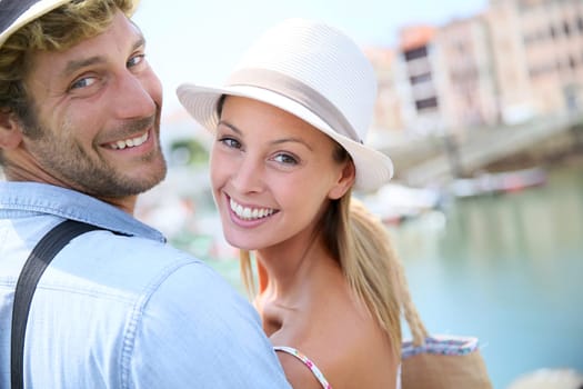 Portrait of cheerful couple in summer vacation at seaside resort