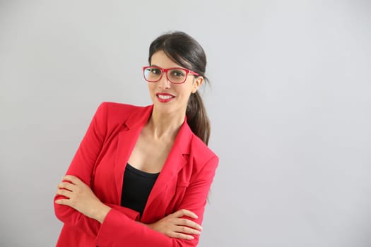 Beautiful brunette girl with red jacket and eyeglasses, isolated
