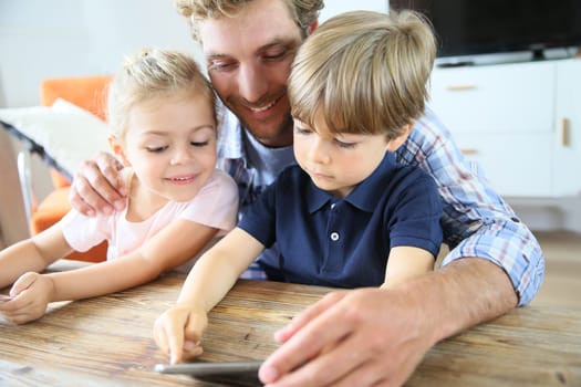 Daddy with kids playing with smartphone