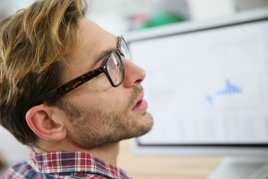 Profile view of trendy guy with eyeglasses on
