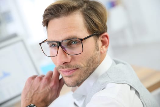 Businessman with eyeglasses working on desktop computer