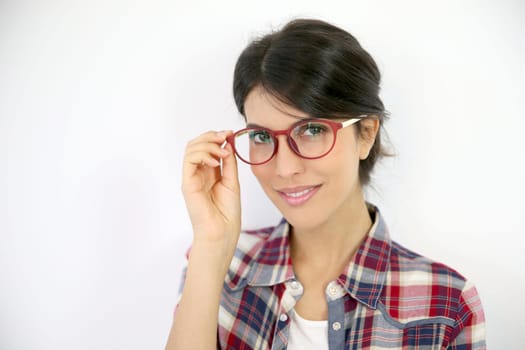 Portrait of brunette girl with red eyeglasses on, isolated