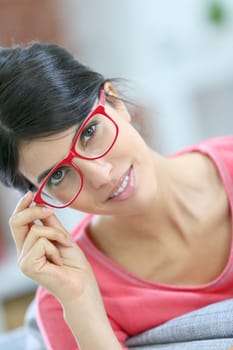 Portrait of beautiful brunette girl wearing red eyeglasses