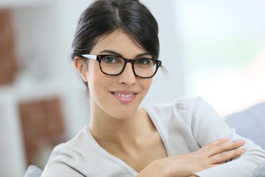 Portrait of beautiful young woman with eyeglasses on