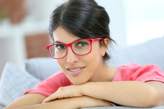 Portrait of beautiful brunette girl wearing red eyeglasses