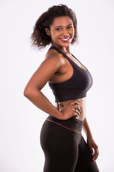 young black woman wearing fitness outfit on white isolated background