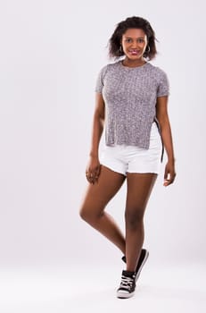 young black woman wearing casual outfit on light grey background