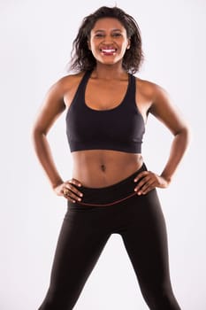 young black woman wearing fitness outfit on white isolated background