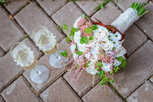 Beautiful wedding bridal bouquet lying on a tree stump made of cotton and blue colors, winter