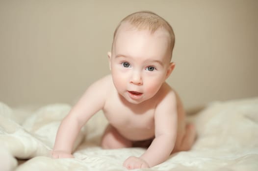 The little boy newborn baby smiling and drooling creeps and lies, Sleeps