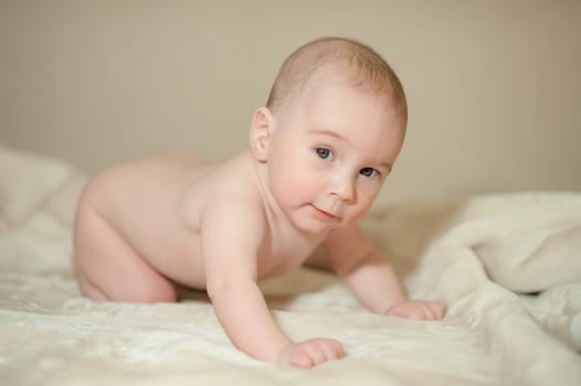 The little boy newborn baby smiling and drooling creeps and lies, Sleeps