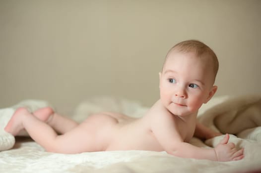 The little boy newborn baby smiling and drooling creeps and lies, Sleeps