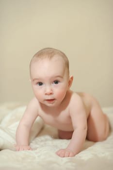 The little boy newborn baby smiling and drooling creeps and lies, Sleeps
