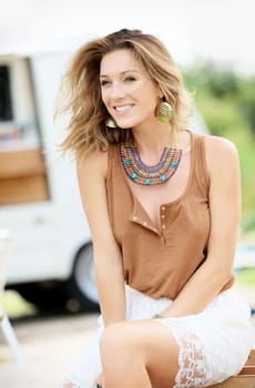 Trendy model girl sitting on outdoor chair
