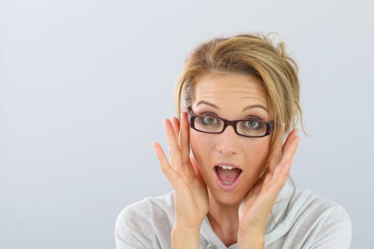 Portrait of blond woman with eyeglasses on, isolated