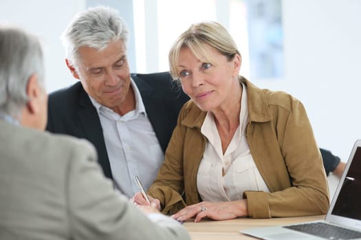 Senior couple meeting real-estate agent for investment